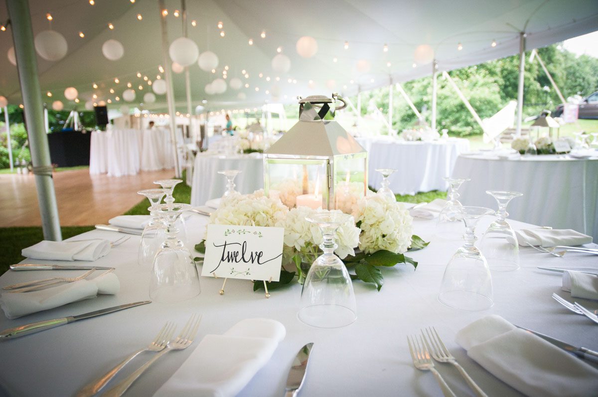 high-school-sweethearts-wed-at-tent-wedding-table-set-with-flowers