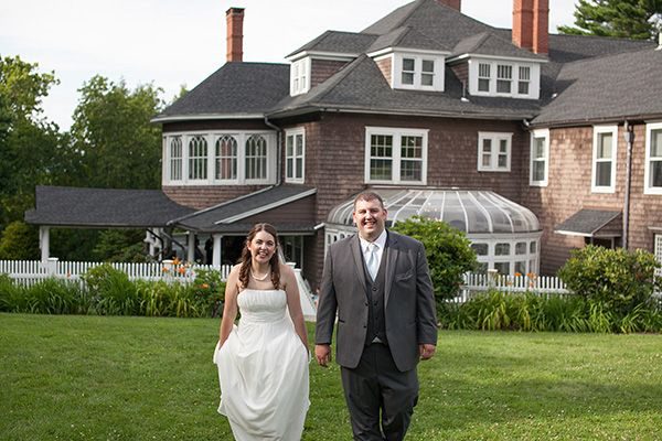 annie and ryan walking across lawn with mansion in the background