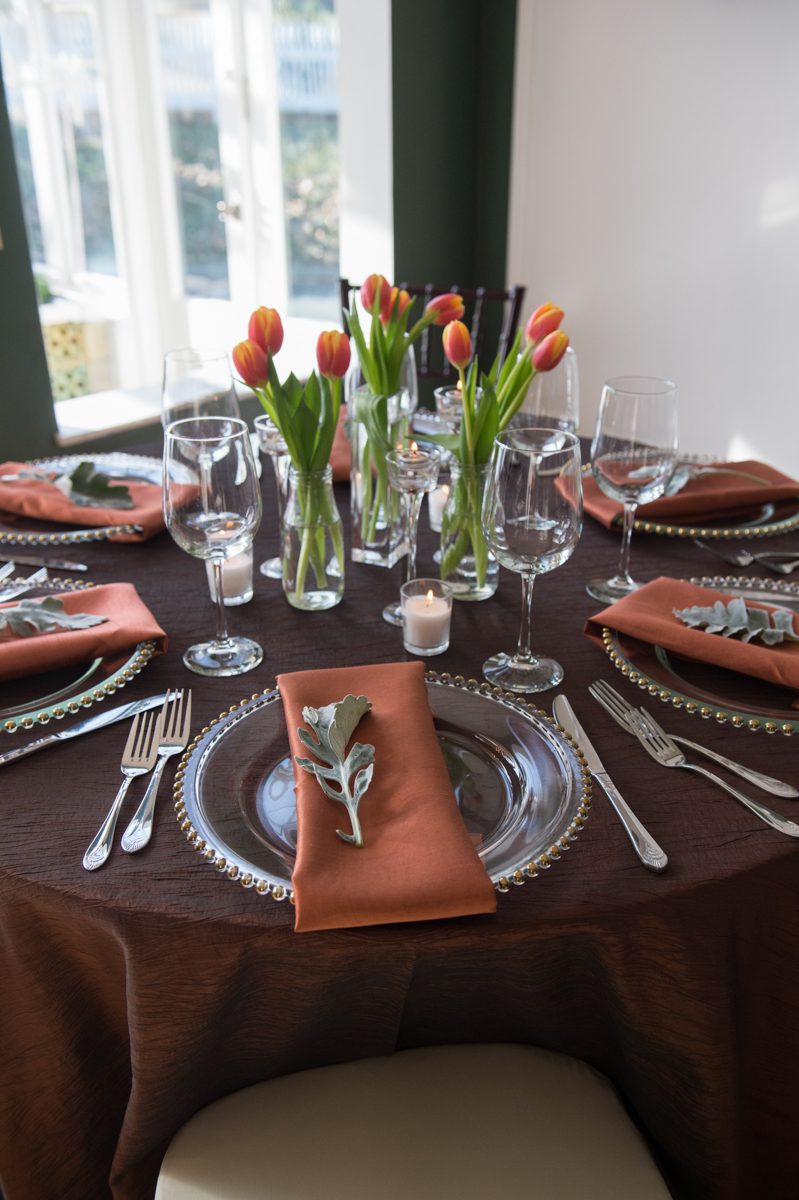 Beautiful spring table settings in varying shades of brown with gold edged plates