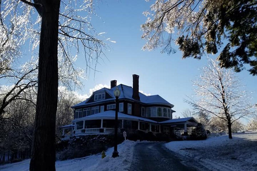 view-of-mansion-from-dirveway-covered-in-ice-and-snow