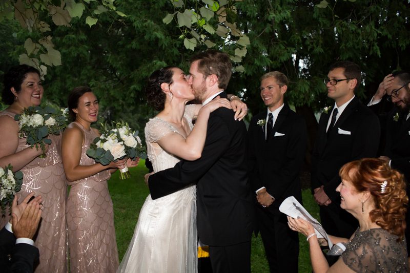 couple-kissing-after-art-deco-ceremony-under-the-grape-arbor