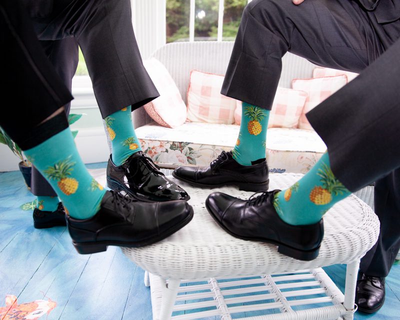 cuban-flair-wedding-four-legs-together-showing-off-their-pinapple-themed-socks