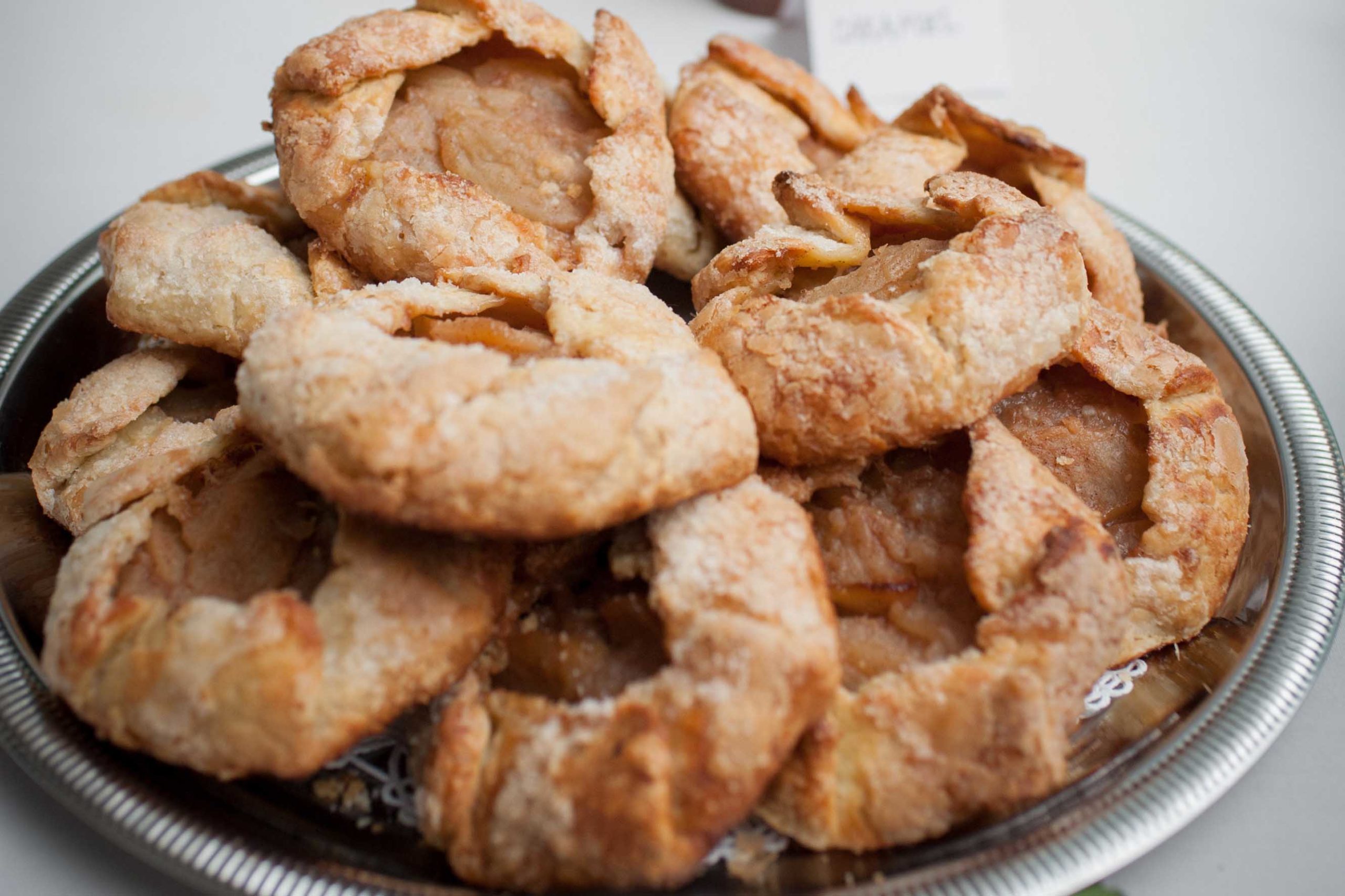 apple tarts piled on plate