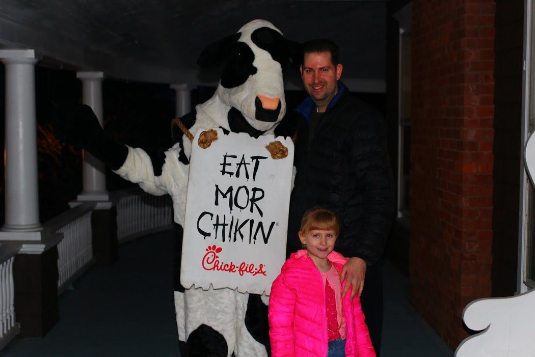 dad, daughter, with cow that says eat more chicken