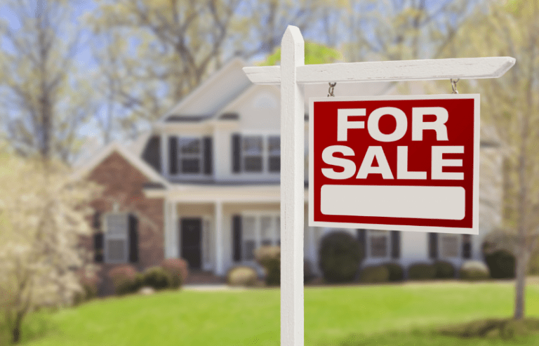 for sale sign on front lawn