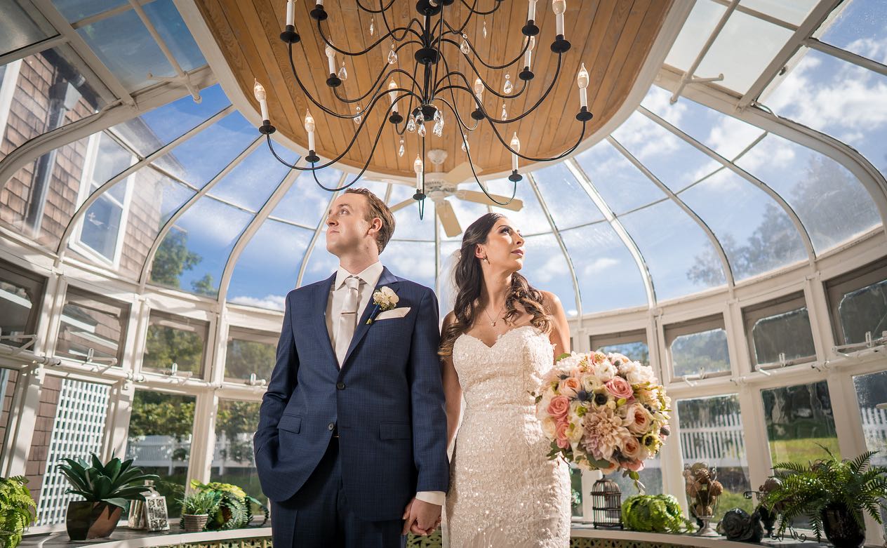 summer-first-look-couple-hand-in-hand-in-glass-conservatory